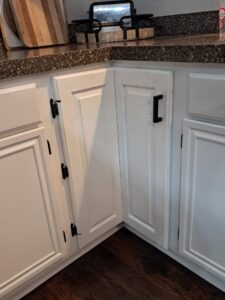 A newly assembled or installed white kitchen island with drawers and a cabinet by Cedar Rapids On Call Handyman Service in Cedar Rapids, IA