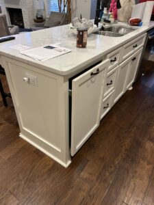 A newly installed kitchen island cabinet with a pull-out trash bin by BK's Handyman Services in Carlton, OR.