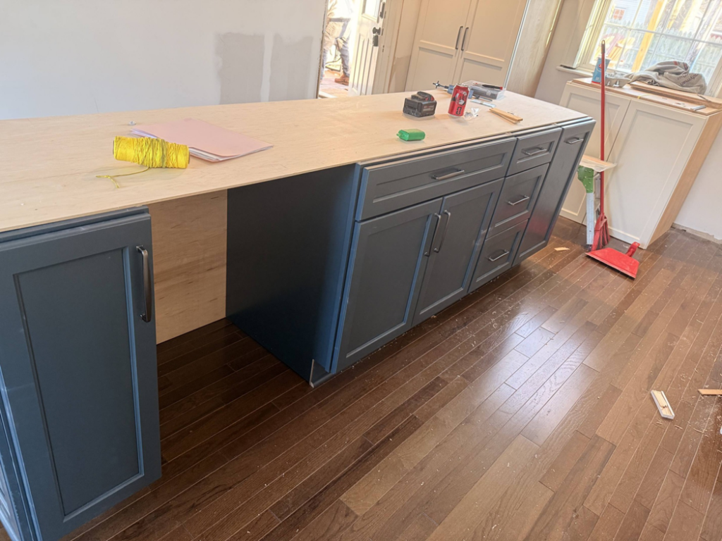 Kitchen island cabinets being installed with tools by E and C Handyman and Construction LLC in Owensboro, KY.