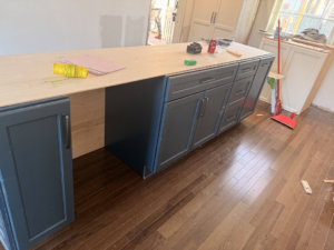 Kitchen island cabinets being installed with tools by E and C Handyman and Construction LLC in Owensboro, KY.