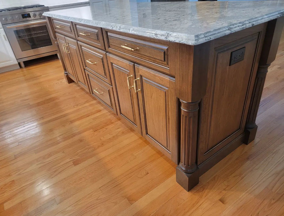 Kitchen island cabinetry and electrical outlet installation by Walker Kitchen Design in Granby, CT.
