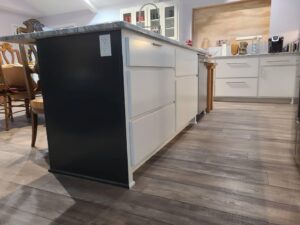 Close-up of a kitchen island with custom cabinetry and an electrical outlet, installed by Holaway Custom Builds in Fayetteville, AR.