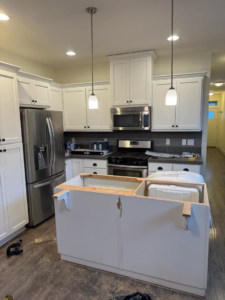 Kitchen island construction in progress, showing framing and plumbing, by Restore Renew Remodel in Portland, OR.