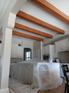 Kitchen island covered for painting preparation with drop cloths by Southeastern Painting & Drywall in Wilmington, NC