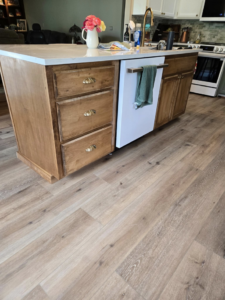 Detailed view of a newly installed kitchen island with drawers and new flooring by Stephen Appel Handyman/Contractor in Meridian, ID.