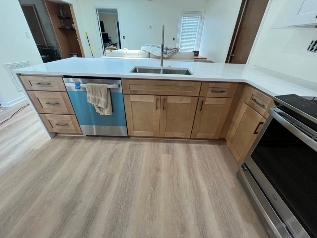 A newly installed kitchen island with sink and dishwasher by Precision Home Improvement in Massapequa, NY.