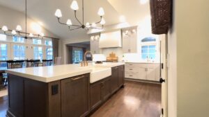 A newly remodeled kitchen featuring a large island with a farmhouse sink by Saunders Dynamic Remodeling in Columbus, OH