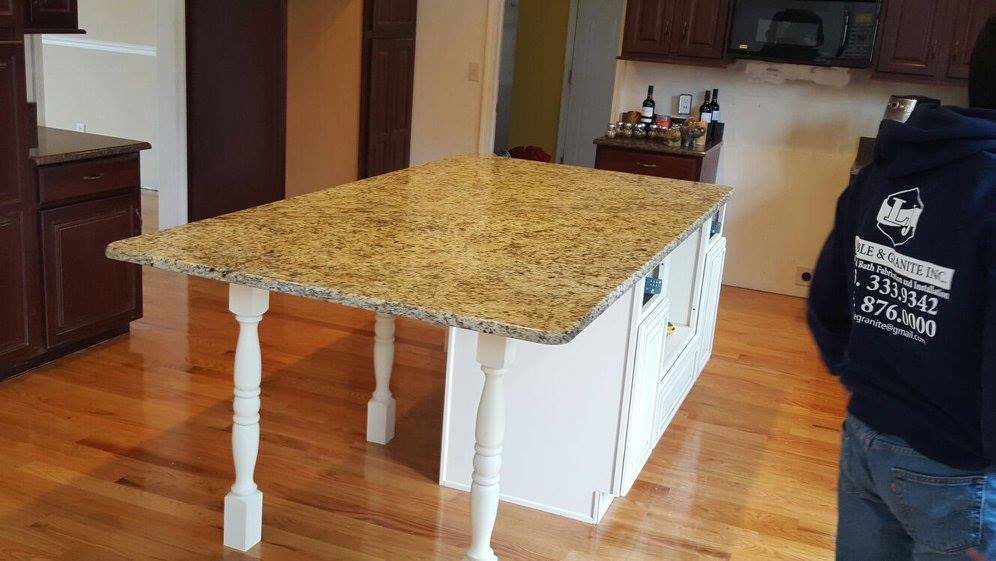 A newly installed kitchen island with a granite countertop by LJ Marble & Granite in Paterson, NJ.