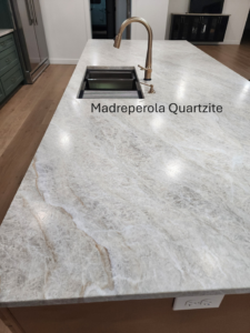 A newly installed kitchen island featuring a Madreperola Quartzite countertop by Slater Cabinets and More in Springfield, MO.