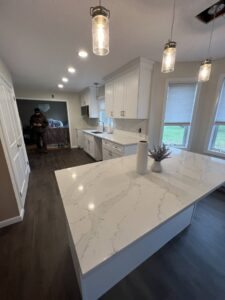 A renovated kitchen featuring a large island and new recessed lighting by Garbatini Contracting in Wallingford, CT.