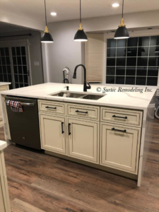 A newly installed kitchen island with a double sink and integrated dishwasher by Surtec Remodeling Inc. in Pittsburgh, PA.