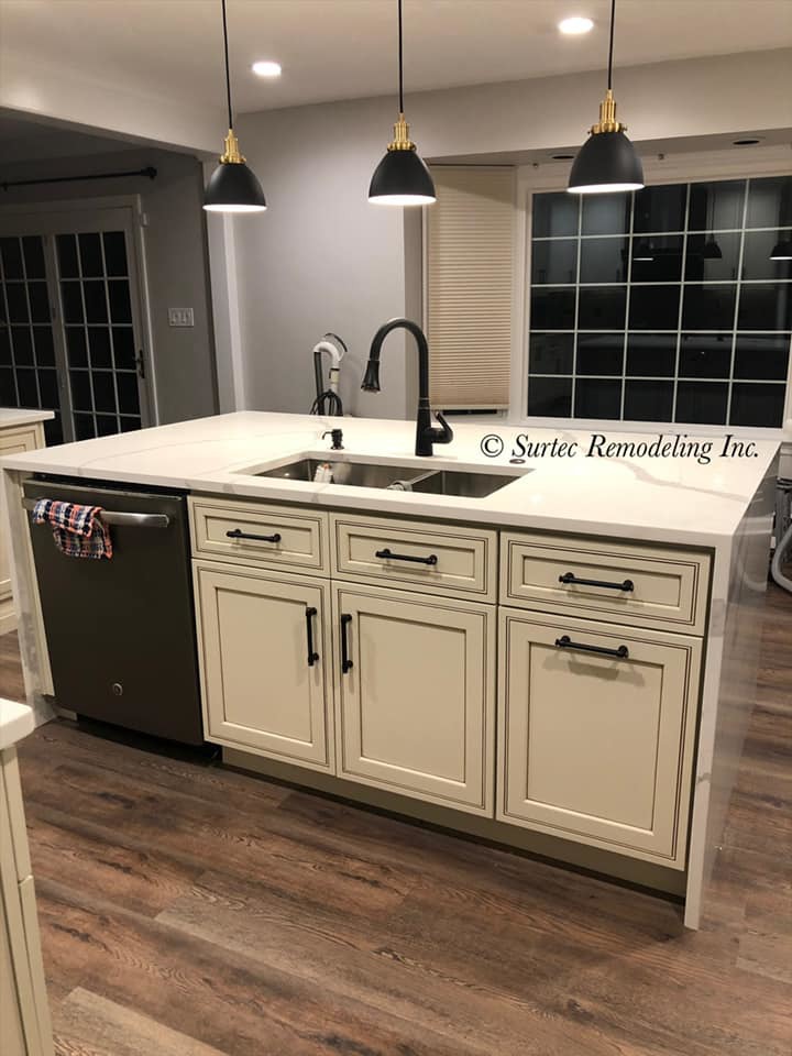 A newly installed kitchen island with a double sink and integrated dishwasher by Surtec Remodeling Inc. in Pittsburgh, PA.
