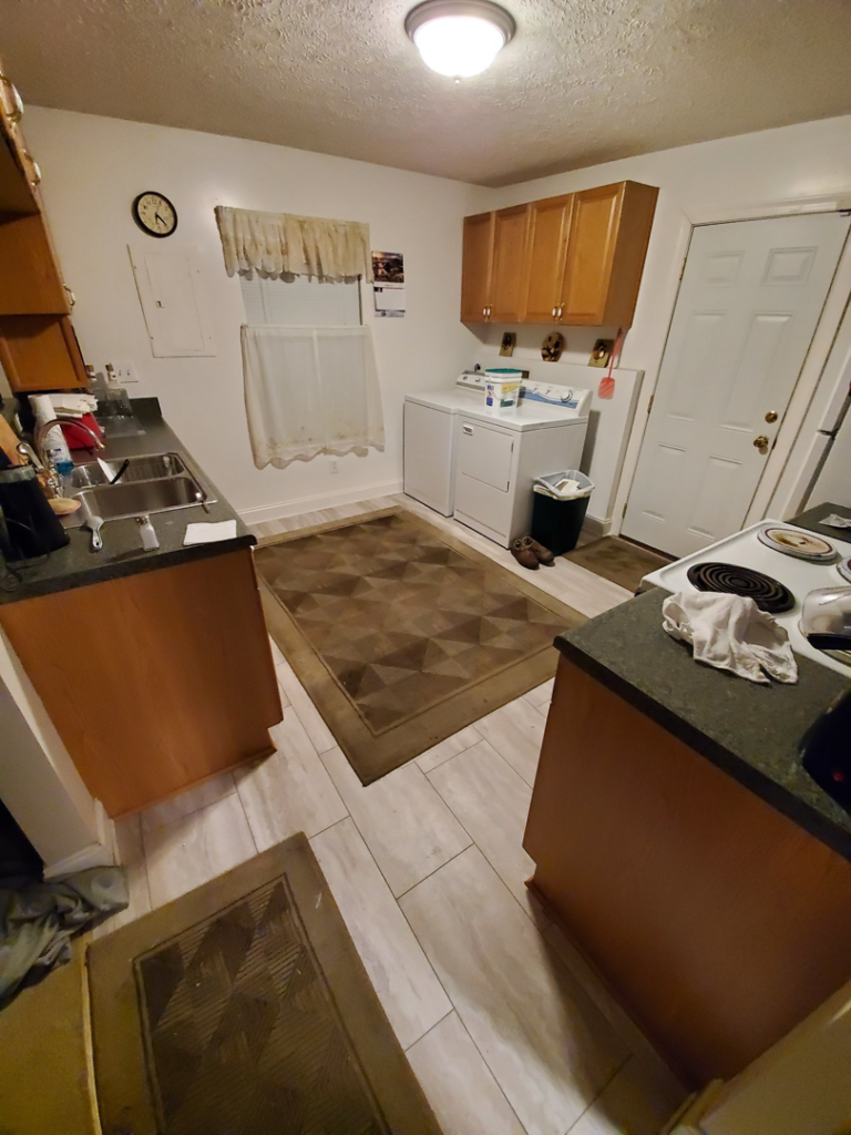 A kitchen and laundry area featuring newly installed tile flooring, a service provided by J & J Home Improvements, LLC in Franklin, TN.