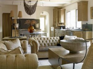 A kitchen and living area remodel featuring light brown cabinets and a farmhouse sink by Kornerstone Kitchens in Orlando, FL.