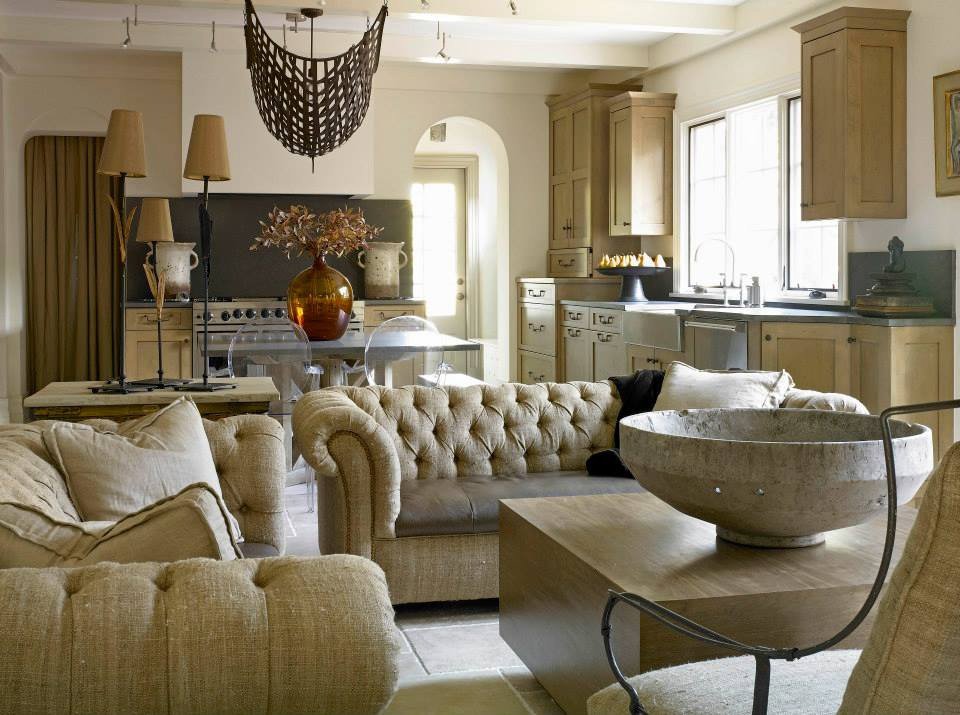 A kitchen and living area remodel featuring light brown cabinets and a farmhouse sink by Kornerstone Kitchens in Orlando, FL.