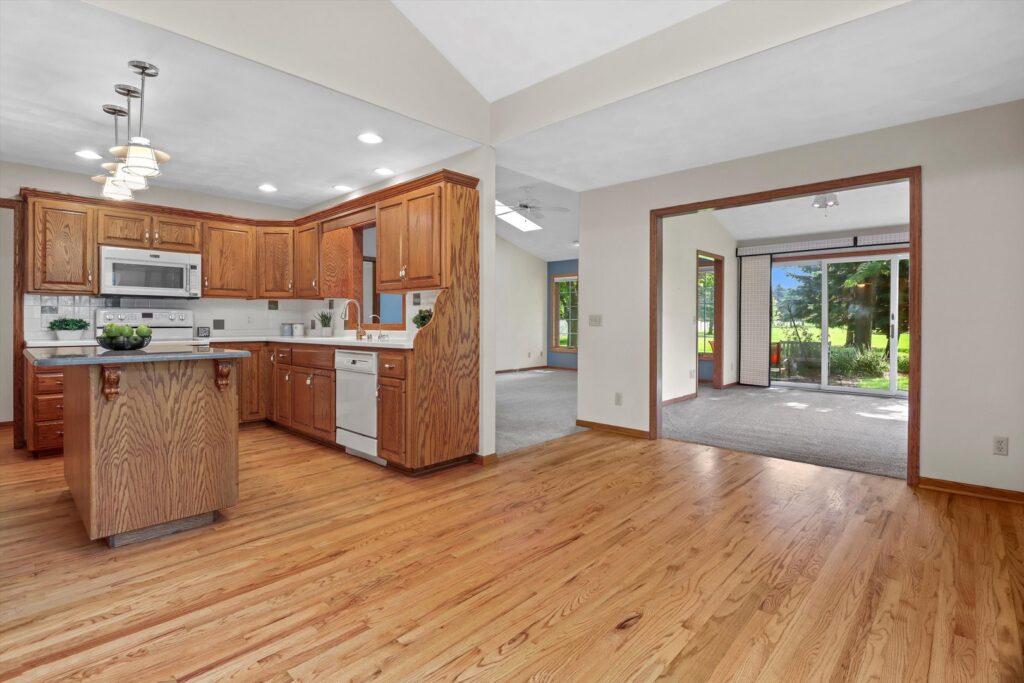 A bright kitchen and living area featuring new hardwood flooring installed by Nelson Hardwood Flooring in Madison, WI.