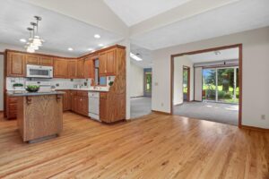 A bright kitchen and living area featuring new hardwood flooring installed by Nelson Hardwood Flooring in Madison, WI.