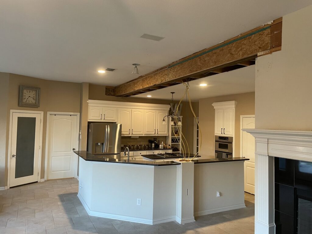 Kitchen and living area open concept conversion by Load Bearing Wall Pros in Plano, TX, with structural work visible.