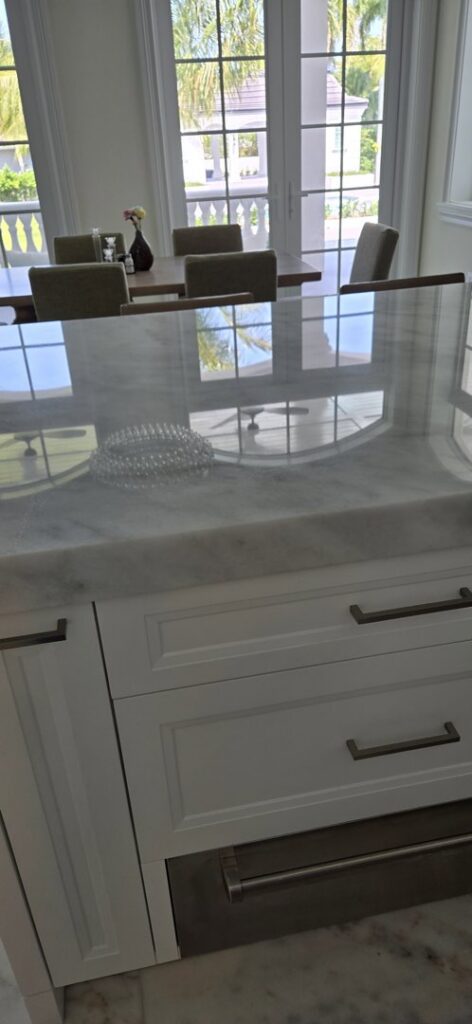 A close-up of a beautifully polished marble countertop in a kitchen, a service provided by Cornerstone Services Management in Miami, FL.