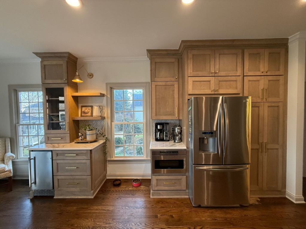A kitchen pantry with custom light wood cabinetry, a built-in refrigerator, and a coffee station, installed by Safe Haven Home Services in Nashville, TN.