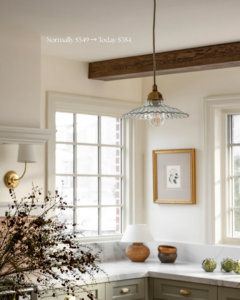 A decorative glass pendant light hanging in a kitchen, illustrating professional light fixture installation by Wiersma Homes in Knoxville, TN.