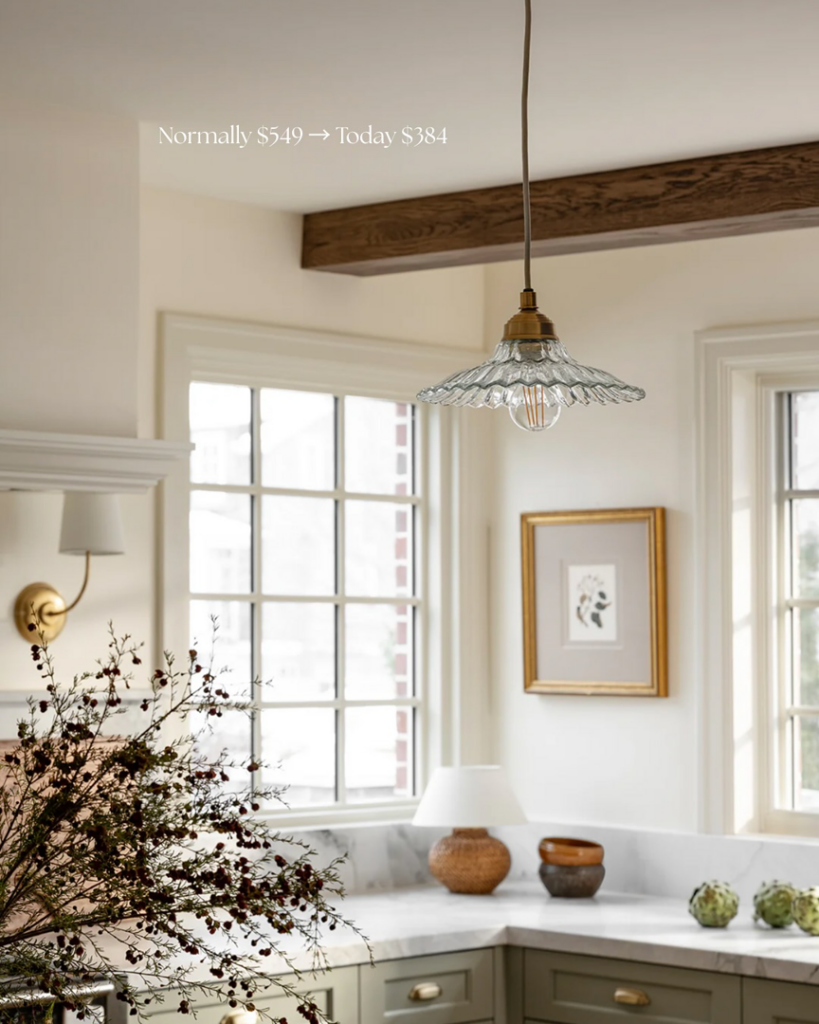 A decorative glass pendant light hanging in a kitchen, illustrating professional light fixture installation by Wiersma Homes in Knoxville, TN.