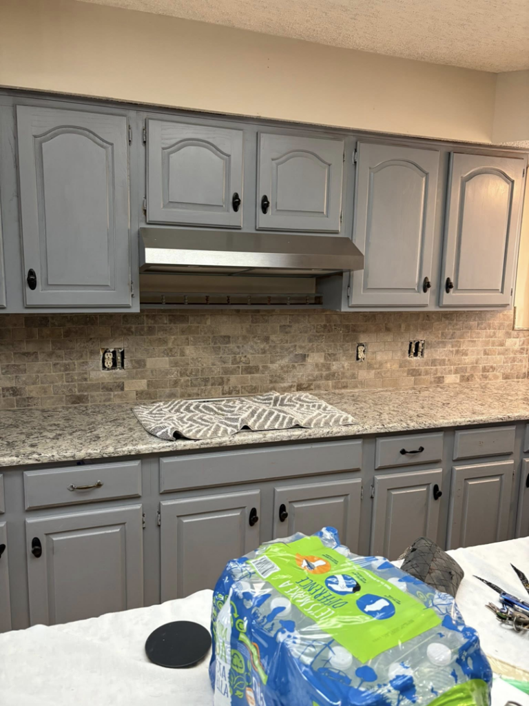 Kitchen showing a newly installed range hood and backsplash by Express Handyman Pros, LLC in Fort Smith, AR