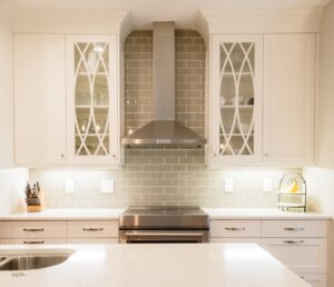 Close-up of a newly installed kitchen range hood and subway tile backsplash, demonstrating services by Boyd's Custom Building in Charlotte, NC.