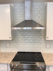 A kitchen featuring a new range hood and a white subway tile backsplash, installed by TPF Services in Yakima, WA.