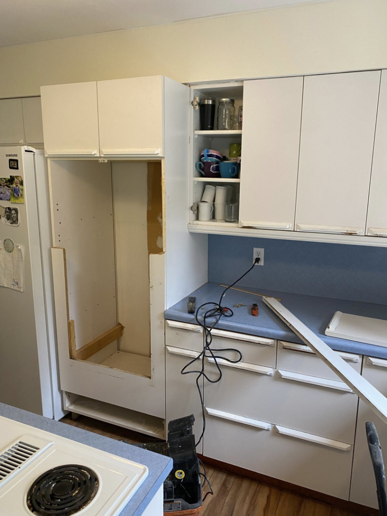 Building out a custom refrigerator cabinet space during a kitchen remodel by Berg Handyman Services in Post Falls, ID
