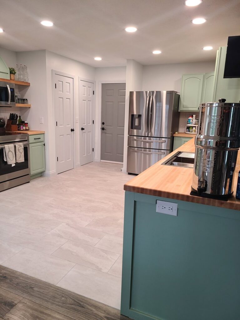 Kitchen with new refrigerator and pantry doors installed by True North Builders in Franktown, CO.