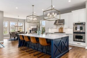 A spacious kitchen remodel with a distinctive blue island and modern appliances by Saunders Dynamic Remodeling in Columbus, OH