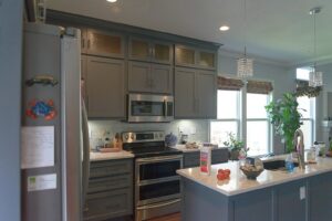 A newly remodeled kitchen with grey cabinets and stainless steel appliances by Westlake Ace Handyman Services Kansas City Metro in Lenexa, KS.