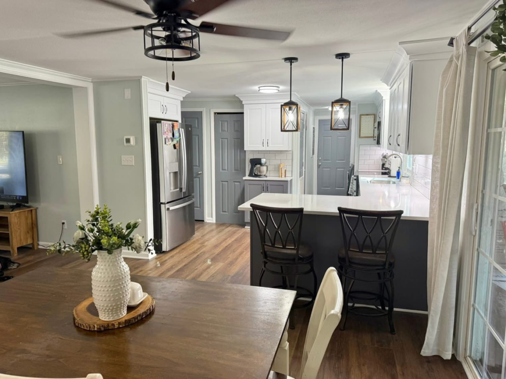 A beautifully remodeled kitchen and dining area with new cabinets, lighting, and flooring by Seaboard Enterprises in Suffolk, VA.