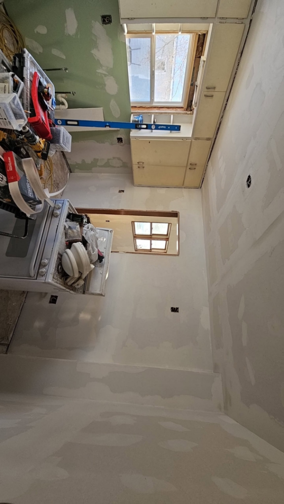 Kitchen remodel in progress with new drywall and cabinet installation by Clausen Construction LLC in Williston, ND