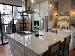 Kitchen remodel featuring an island and large glass doors by Cabido Design, a handyman service in Brentwood, MD.