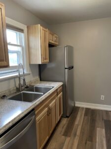 A newly remodeled kitchen with light wood cabinets and granite countertops by HandyMation in Cheyenne, WY