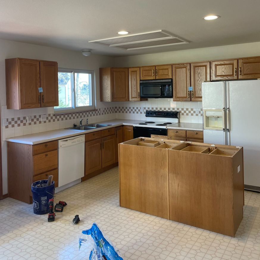 A kitchen remodel in progress with existing cabinets and new island bases by Alpine Contracting in Colorado Springs, CO