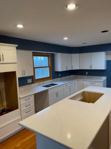 A kitchen remodel in progress with new white cabinets, white countertops, and blue walls by KLS Remodel in Cincinnati, OH.