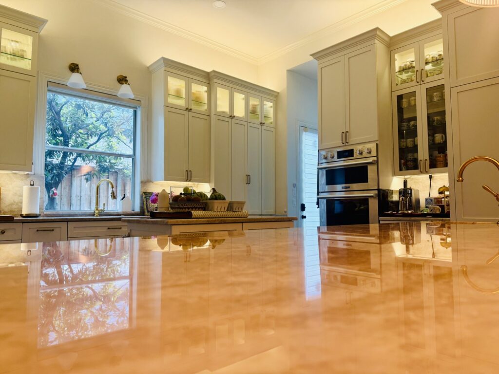 A bright kitchen remodel featuring light-colored cabinets, a large island, and ample natural light by Home Platinum Services, LLC in Plano, TX