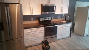 A completed kitchen remodel with new cabinets and appliances by Priority One Home Repair LLC in Glendale, AZ