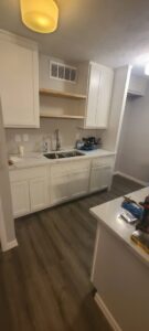 A newly remodeled kitchen featuring new white cabinets and countertops by Finesse Painting and Remodeling in Fort Worth, TX.