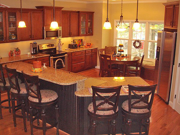 A beautiful kitchen remodel with new cabinets, granite countertops, and island by Tim Moss & Sons Home Improvement in Greensboro, NC.