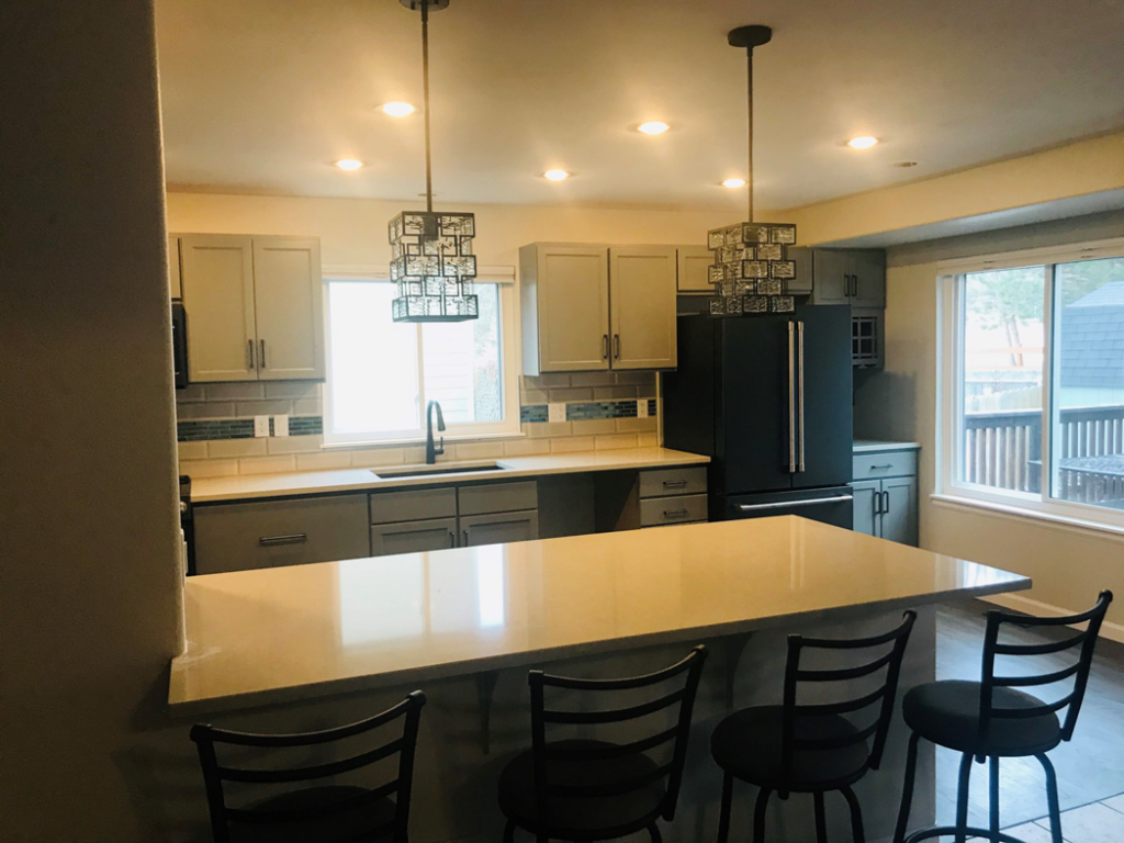 A beautifully renovated kitchen featuring new cabinets, countertops, and lighting by Tanner Custom Carpentry in Loveland, CO.
