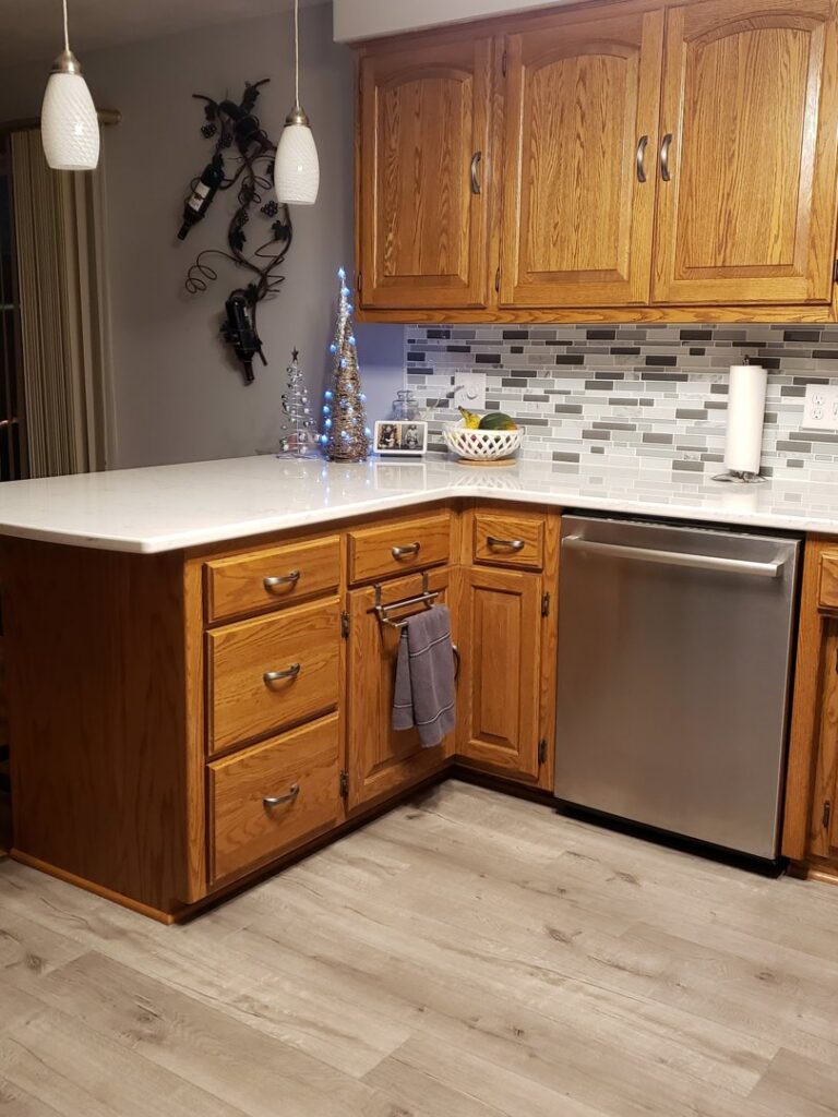 A beautifully remodeled kitchen featuring new countertops and a stylish backsplash by GCB Home Improvement in Appleton, WI.
