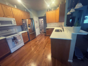 Overview of a kitchen remodel showcasing new countertops and backsplash by Tanner Custom Carpentry in Loveland, CO.