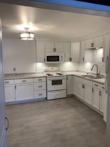 Complete kitchen remodel featuring new white cabinets and appliances by Segovia LLC interiors in Madison, WI.