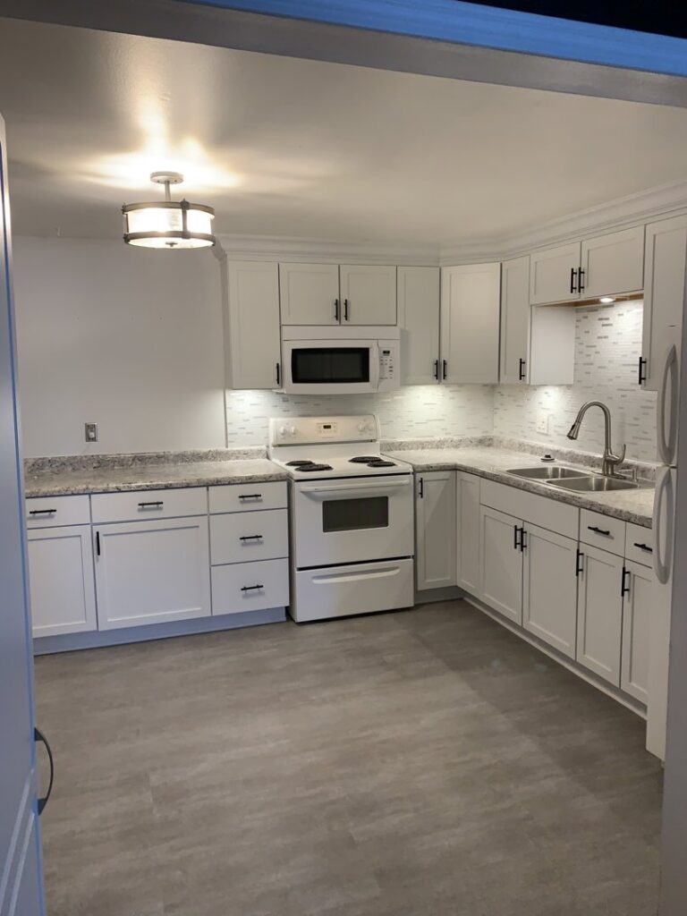 Complete kitchen remodel featuring new white cabinets and appliances by Segovia LLC interiors in Madison, WI.