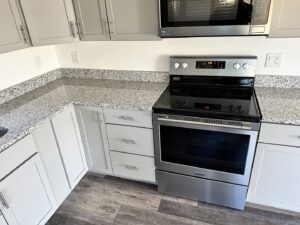 Full kitchen remodel featuring new cabinets, granite countertops, and stainless steel appliances by Top Notch Contracting in Racine, WI.