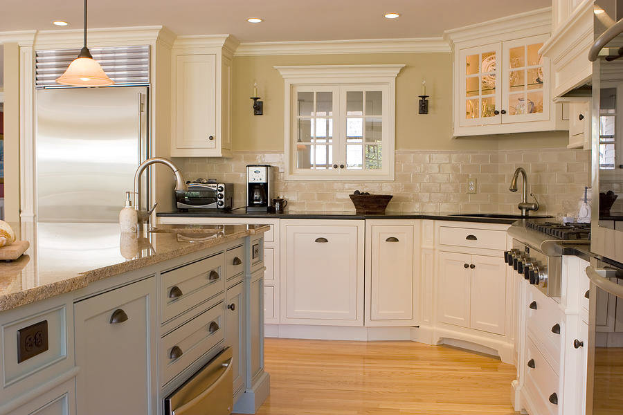 A beautiful kitchen remodel with white cabinets and an island by Indy Renovation in Indianapolis, IN.